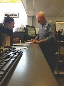 Paul Davidson, retired senior vice president for a Fortune 500 company, at his shop's service desk with a customer. 