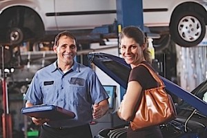 Auto mechanic with customer