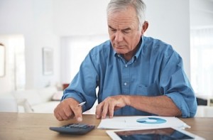 man with calculator and papers